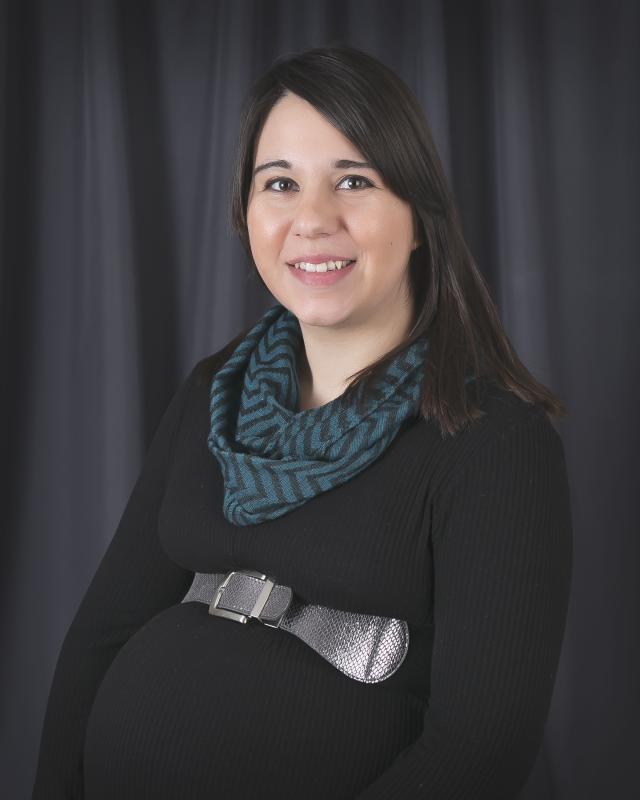 Expectant mother with long hair smiling